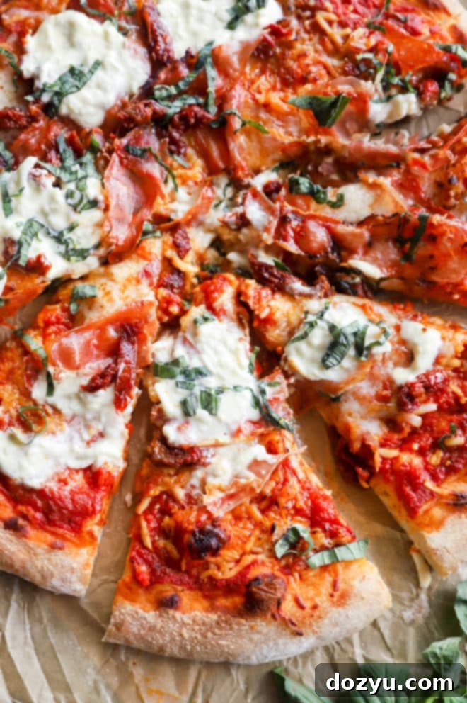Fire-Kissed Burrata Pizza 4 Image of cheese on pizza with fresh basil