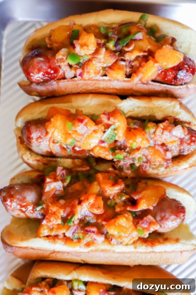 Sweet & Smoky Brats with a Peach-Bacon Kick 8 Overhead image of brats with peach salsa on top
