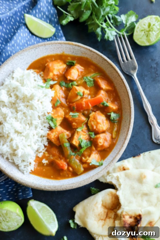 Easy Instant Pot Pumpkin Chicken Curry 2 Overhead image of a vibrant, Thai-inspired pumpkin chicken curry served in a bowl with fresh cilantro and lime