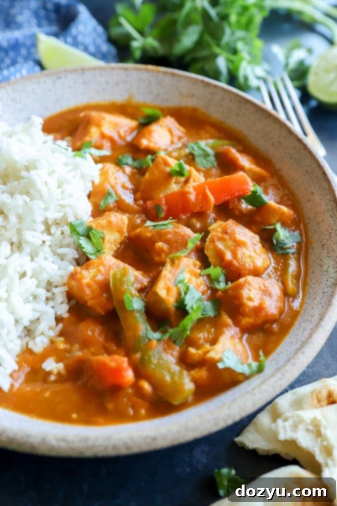 Easy Instant Pot Pumpkin Chicken Curry 9 Instant Pot curry chicken in a bowl with rice and fresh herbs, a comforting meal