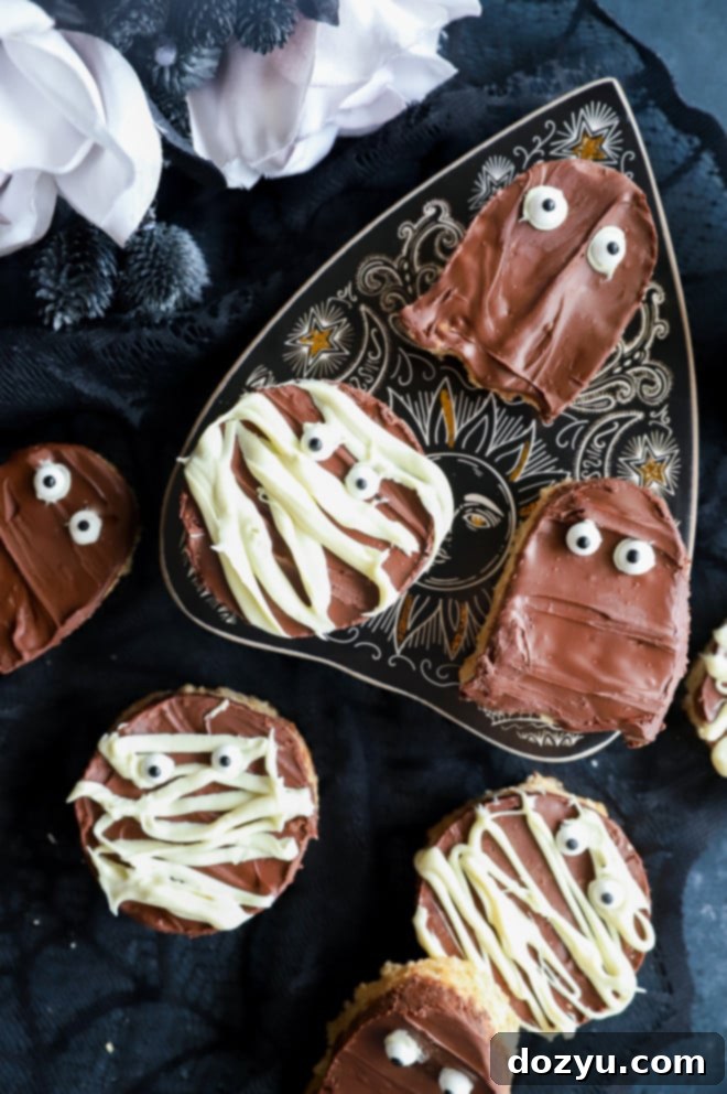 Wicked Choco-Nut Butter Krispie Squares 2 Festive Halloween treats featuring chocolate and peanut butter on a decorated table.