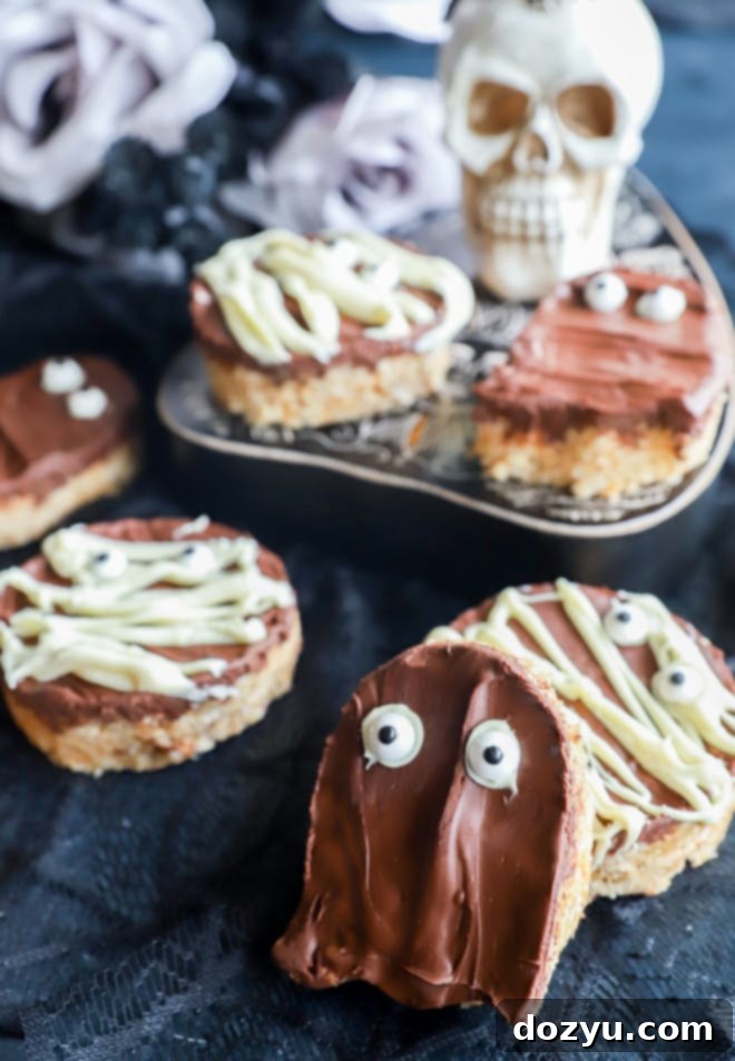 Wicked Choco-Nut Butter Krispie Squares 3 Halloween themed peanut butter Rice Krispie treats arranged on a Ouija board.