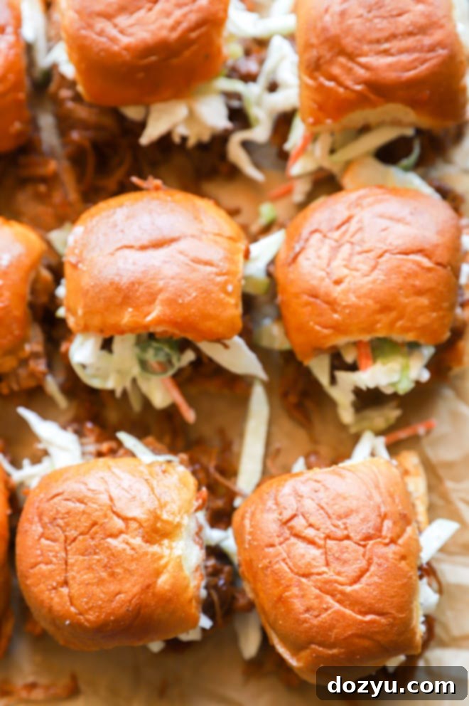 Tender BBQ Pulled Pork Sliders with Tangy Apple Coleslaw 10 Image of sandwiches with apple coleslaw, ready to be served