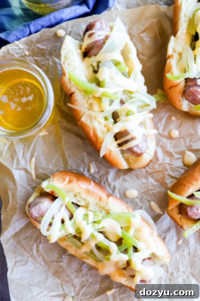 Philly Cheesesteak Beer Brats 2 Drunken Philly Cheesesteak Grilled Bratwurst, topped with beer-braised vegetables and creamy cheese sauce.