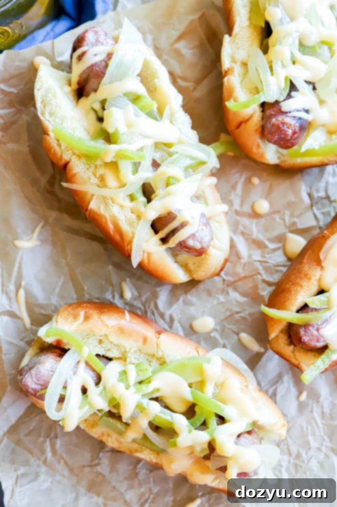 Philly Cheesesteak Beer Brats 9 Two grilled brats in paper boat, generously topped with beer-braised vegetables and cheese sauce.