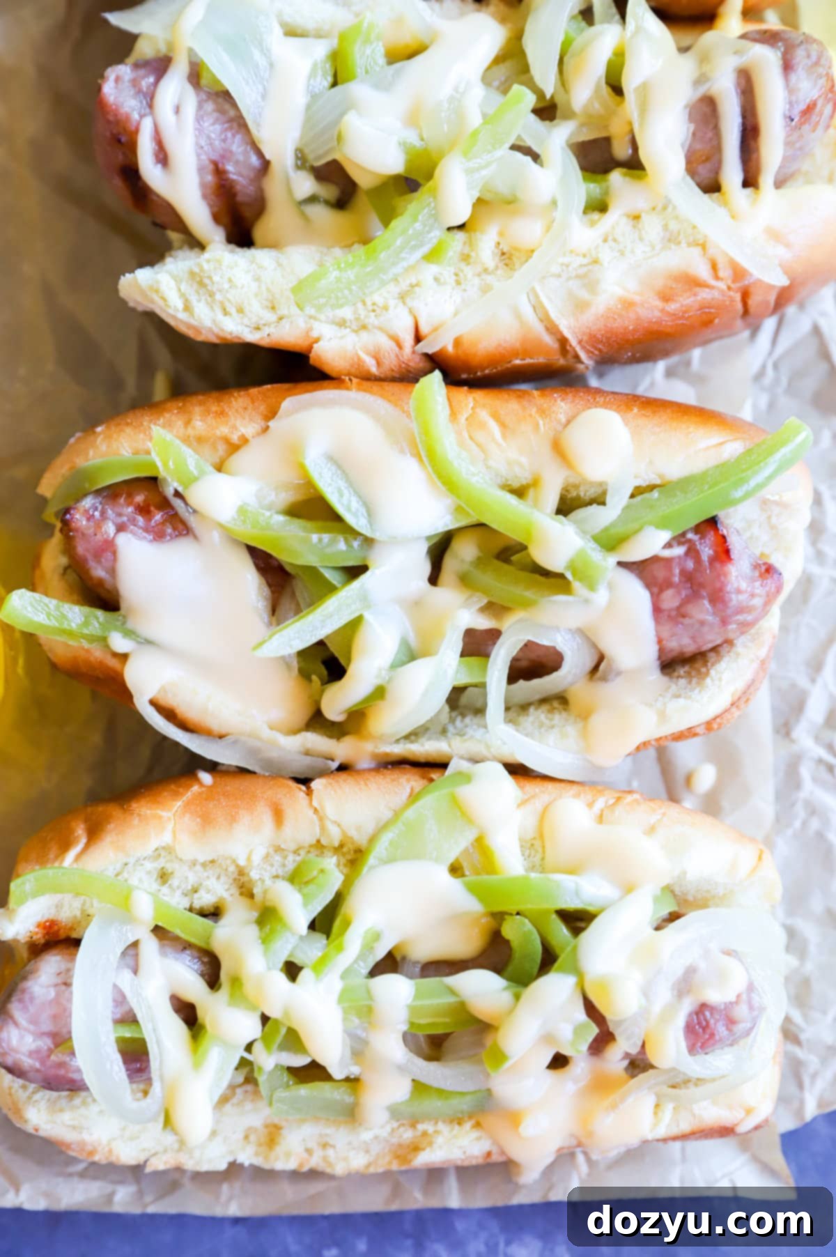 Philly Cheesesteak Beer Brats 12 Overhead image of two Drunken Philly Cheesesteak Grilled Bratwursts.