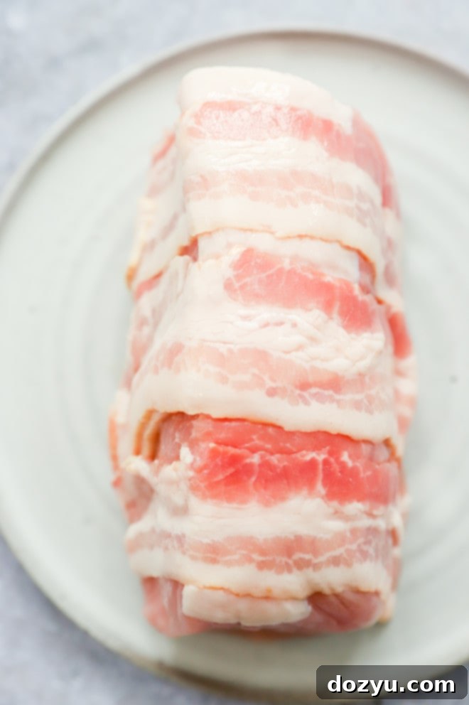 Crispy Air Fryer Bacon Wrapped Pork Loin 5 Uncooked bacon wrapped pork tenderloin image