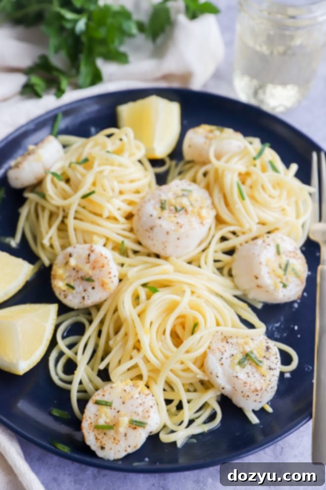 Effortless Air Fryer Scallops with Bright Chive Lemon Butter 10 Plate of seafood linguine topped with air fryer scallops and butter sauce
