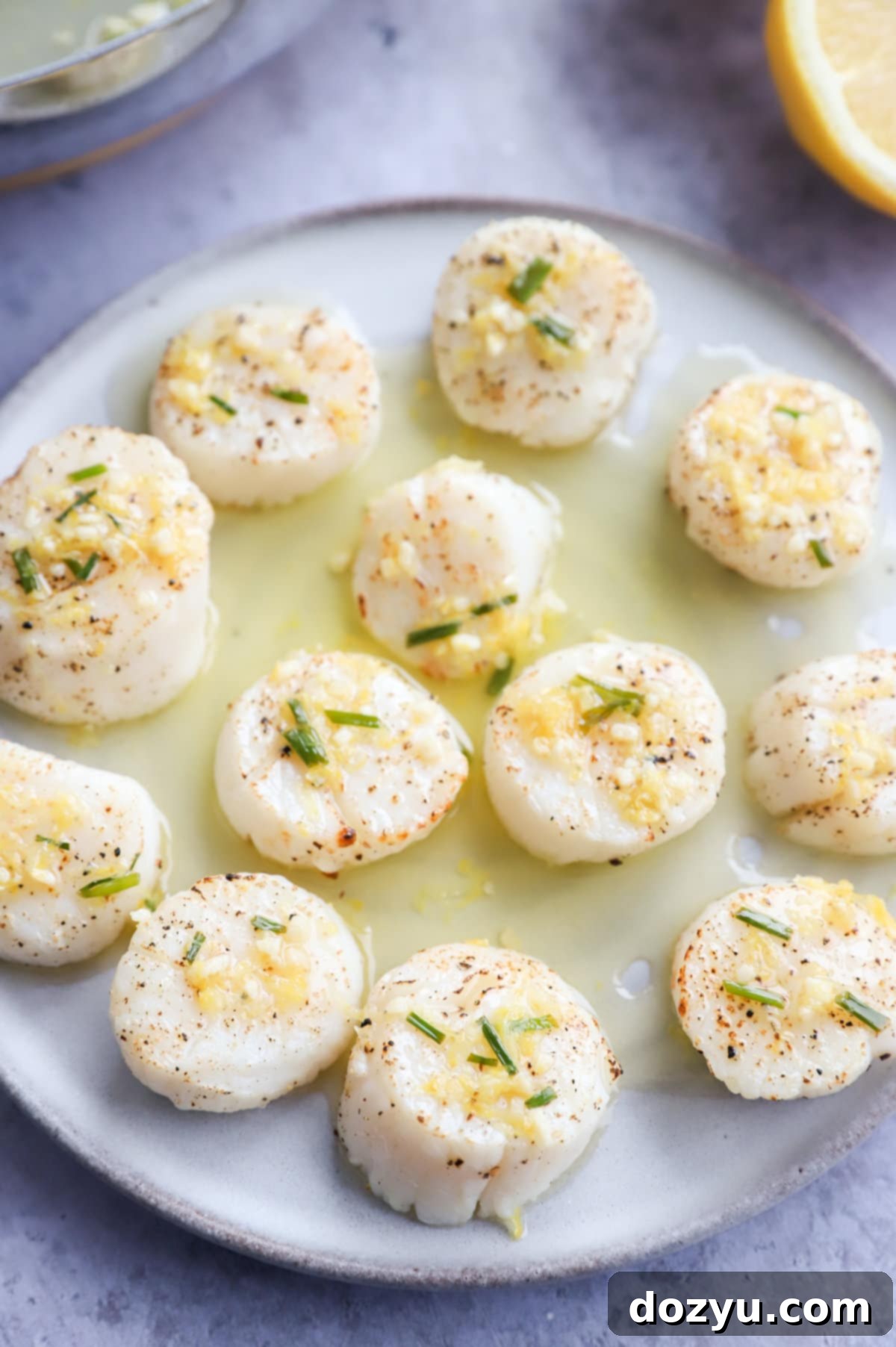 Effortless Air Fryer Scallops with Bright Chive Lemon Butter 11 Air fryer scallops on a plate with chive butter