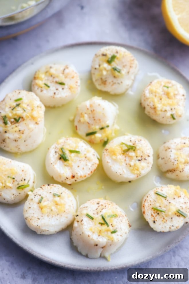 Effortless Air Fryer Scallops with Bright Chive Lemon Butter 3 Air fryer scallops on a plate with chive butter, ready to serve