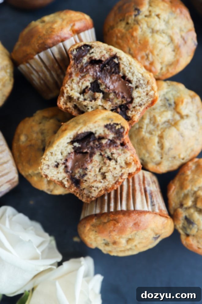 Decadent One-Bowl Banana Nutella Muffins 8 Muffin sliced in half to show the gooey Nutella center