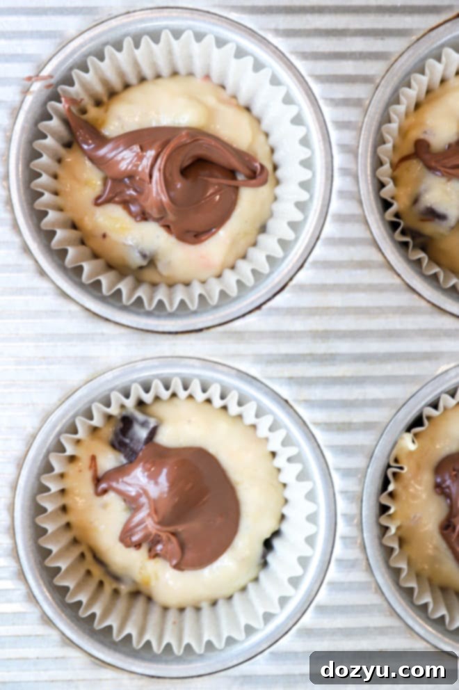 Decadent One-Bowl Banana Nutella Muffins 5 Ingredients for banana nutella muffins laid out on a table