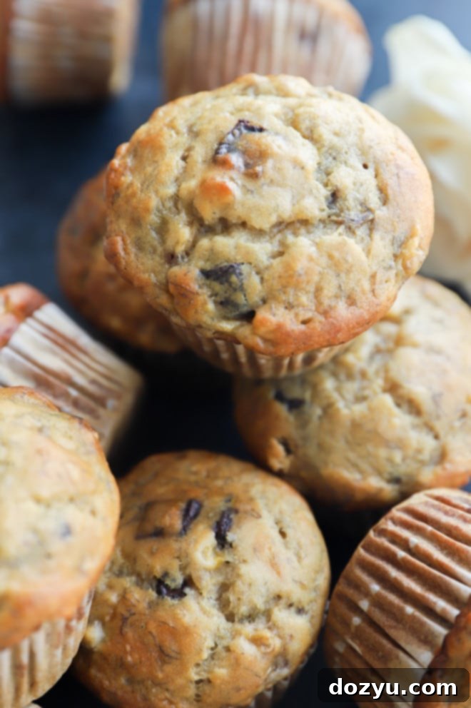 Decadent One-Bowl Banana Nutella Muffins 7 Close up photo of freshly baked muffin with a glimpse of the Nutella center
