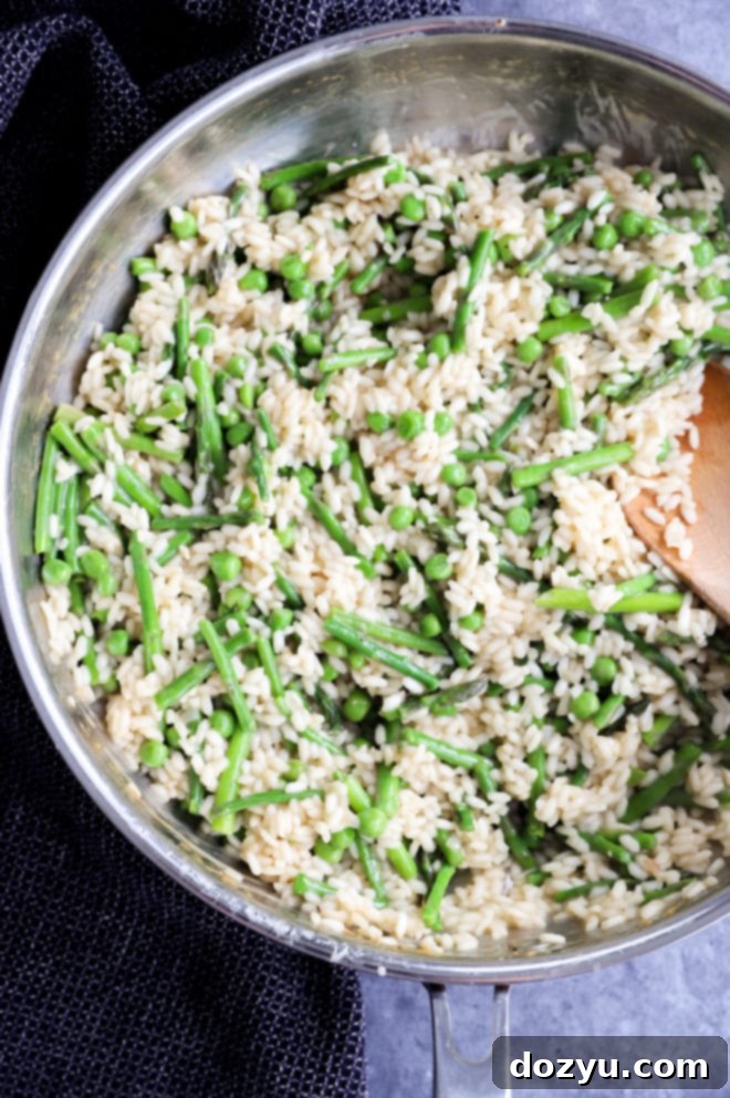 Simple Spring Risotto with Asparagus and Peas 3 Springtime risotto in a skillet with spoon picture