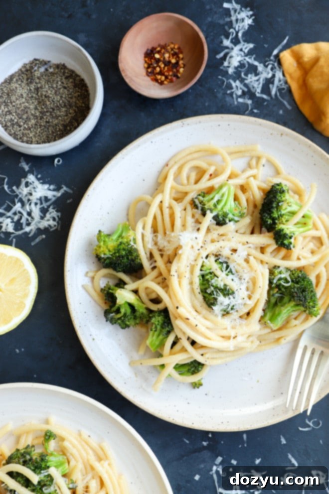 Vibrant Bucatini Cacio e Pepe with Broccoli 9 Plate of pasta with broccoli image with forks