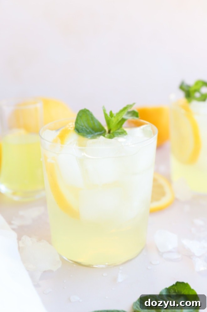 Limoncello Spritz 2 Limoncello Spritz cocktail in glasses image, garnished with fresh lemon and mint