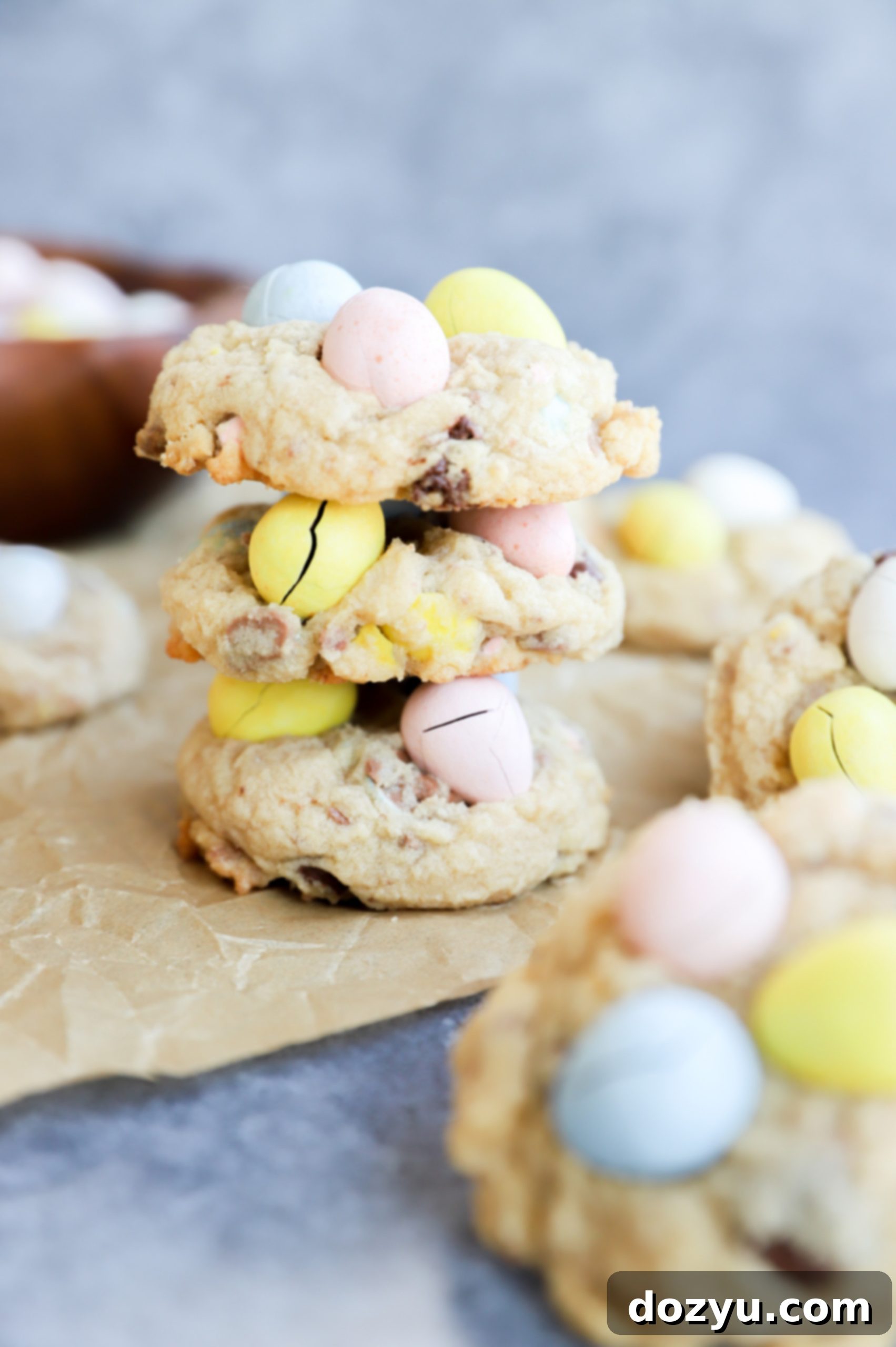 Colorful Mini Egg Cookies 7 Stack of Easter treats on parchment paper, including a stack of Mini Eggs cookies
