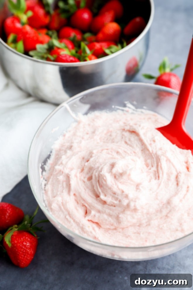 Luscious Strawberry Buttercream Frosting 7 fresh berry cake decoration in a bowl with a spatula and fresh fruit