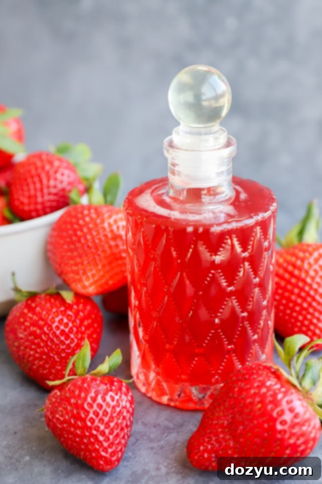 Homemade Strawberry Simple Syrup 2 Image of fruity simple syrup in bottle with fruit