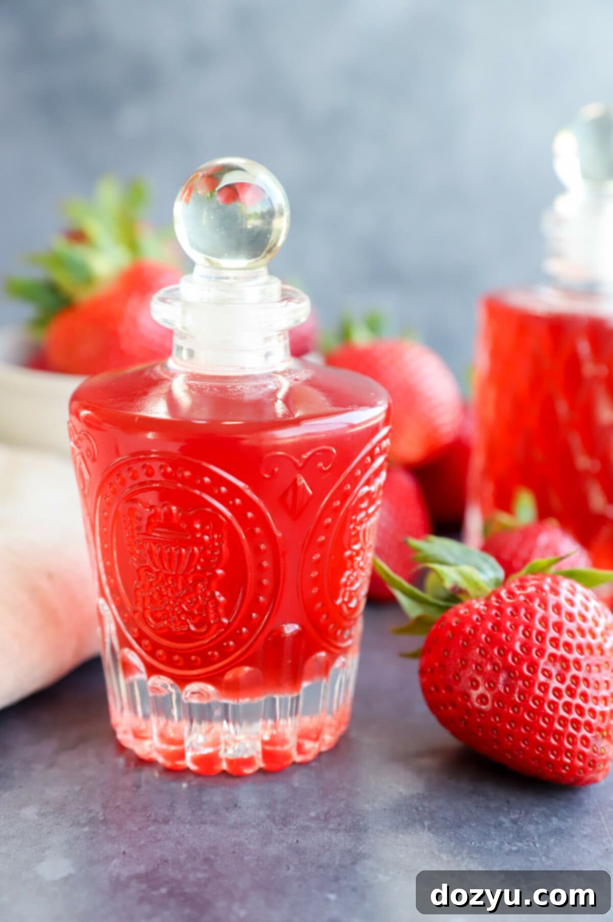 Homemade Strawberry Simple Syrup 5 strawberry simple syrup in bottles with fresh berries image