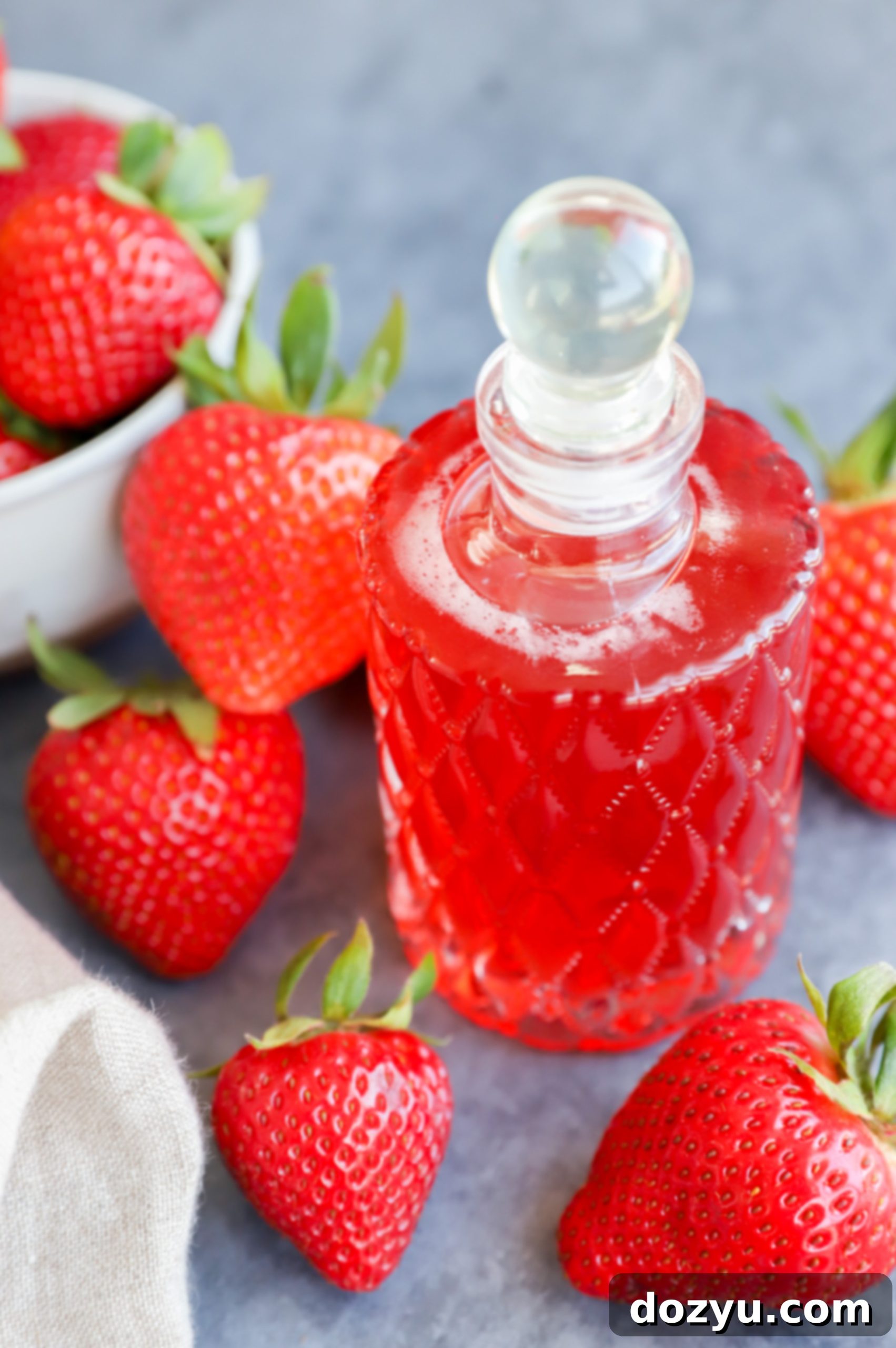 Homemade Strawberry Simple Syrup 6 Image of strawberries and syrup in a jar with fruit