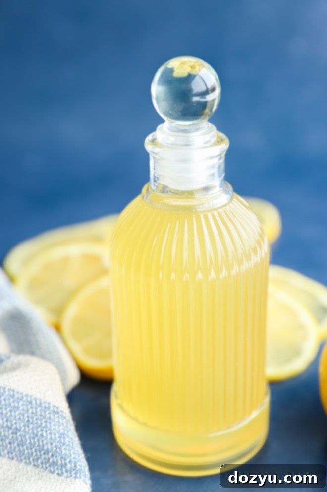 Zesty Lemon Syrup 2 Side photo of lemon simple syrup in a jar