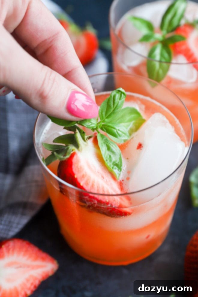 Verdant Basil Syrup 7 A vibrant strawberry basil margarita garnished with fresh basil, ready to be enjoyed.