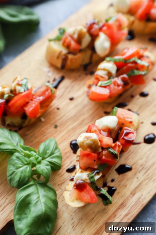 Caprese Bruschetta 3 Picture of bruschetta on platter with fresh basil