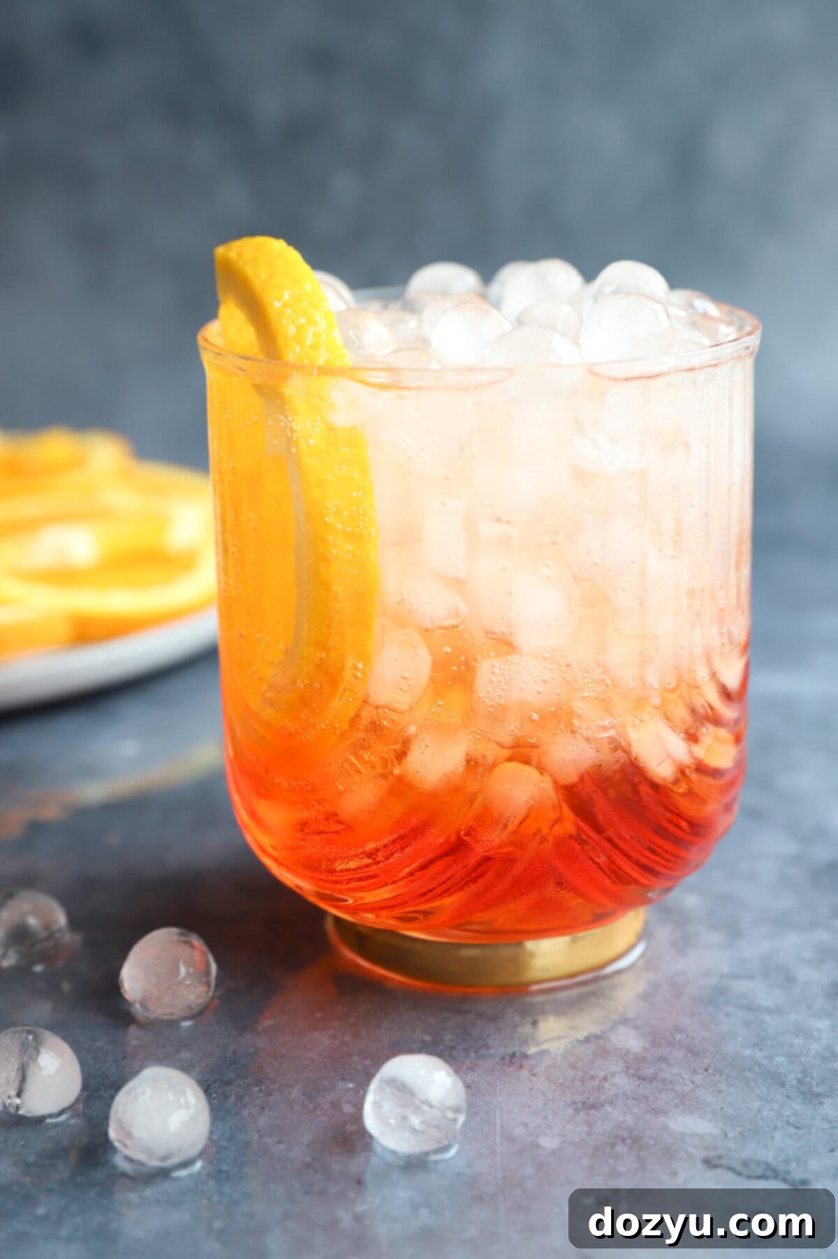 Aperol Fizz 10 Aperol Soda cocktail in a glass, garnished with an orange slice, ready to be enjoyed.