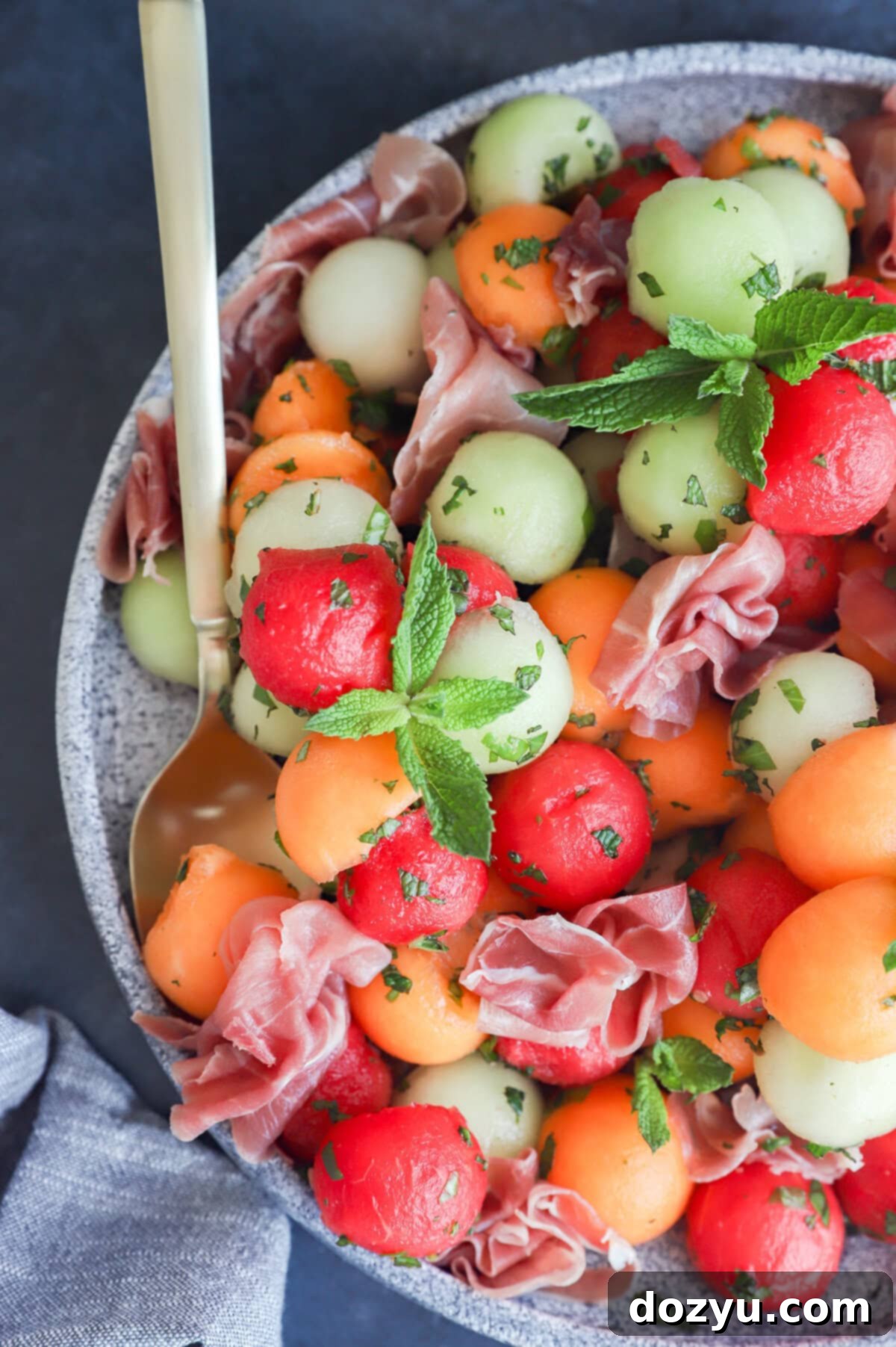 Sweet and Salty Melon Prosciutto Salad 2 Melon prosciutto salad on platter overhead image