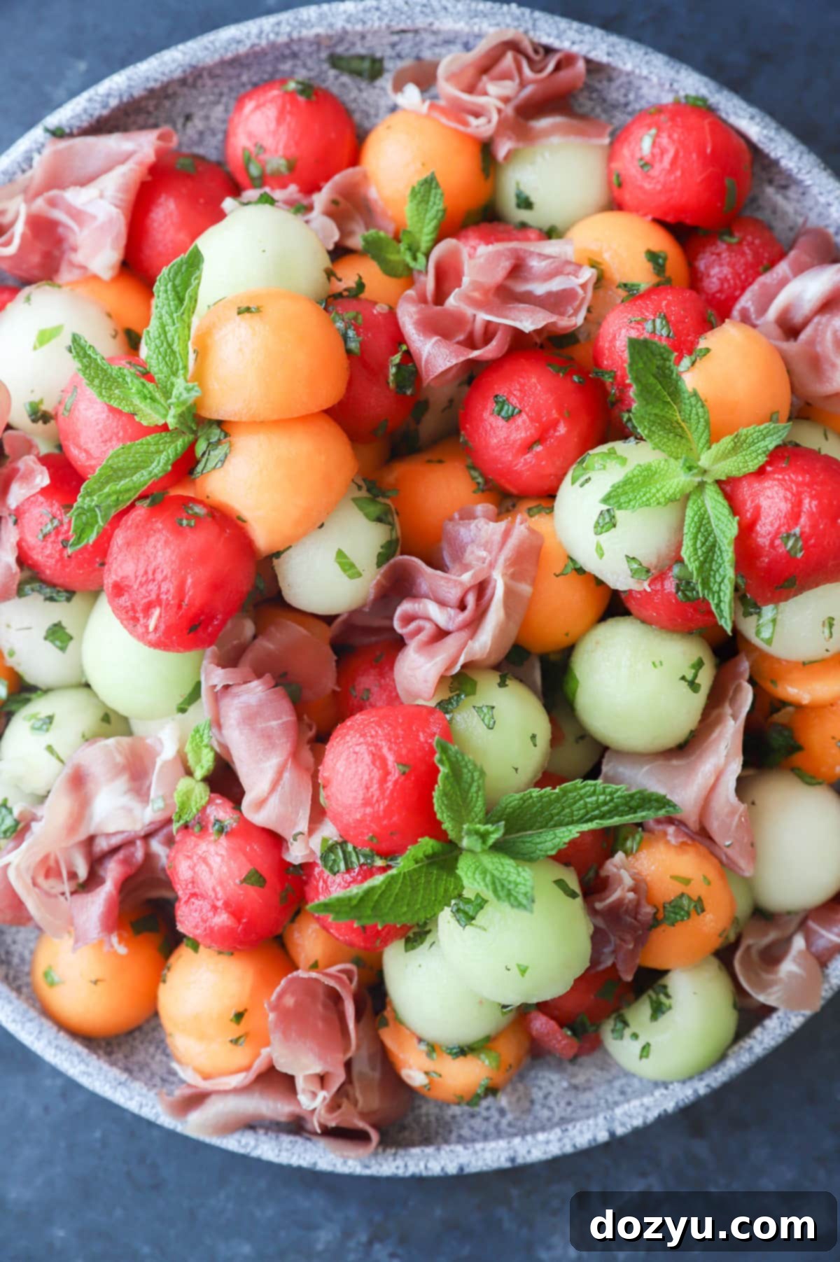 Sweet and Salty Melon Prosciutto Salad 12 Melon prosciutto salad on platter image