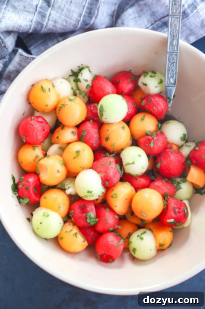 Sweet and Salty Melon Prosciutto Salad 10 Overhead image of making a fruit salad with dressing