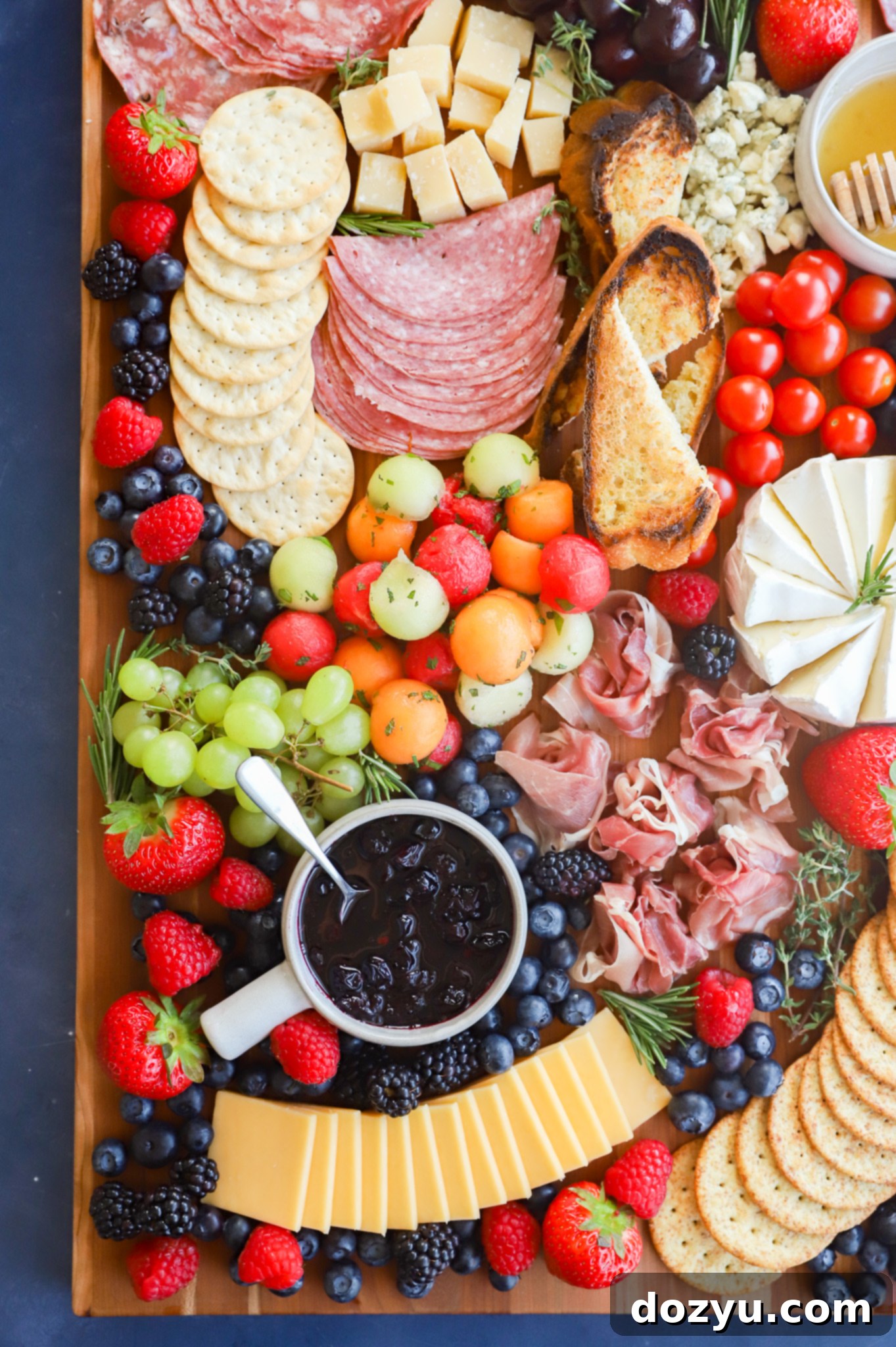 Effortless Summer Grazing Board 8 Overhead image of a bountiful platter of cheeses, meats, and fruits perfect for summer
