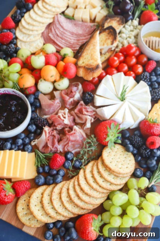 Effortless Summer Grazing Board 9 Close-up summer charcuterie board photo with various cheeses, fruits, and crackers