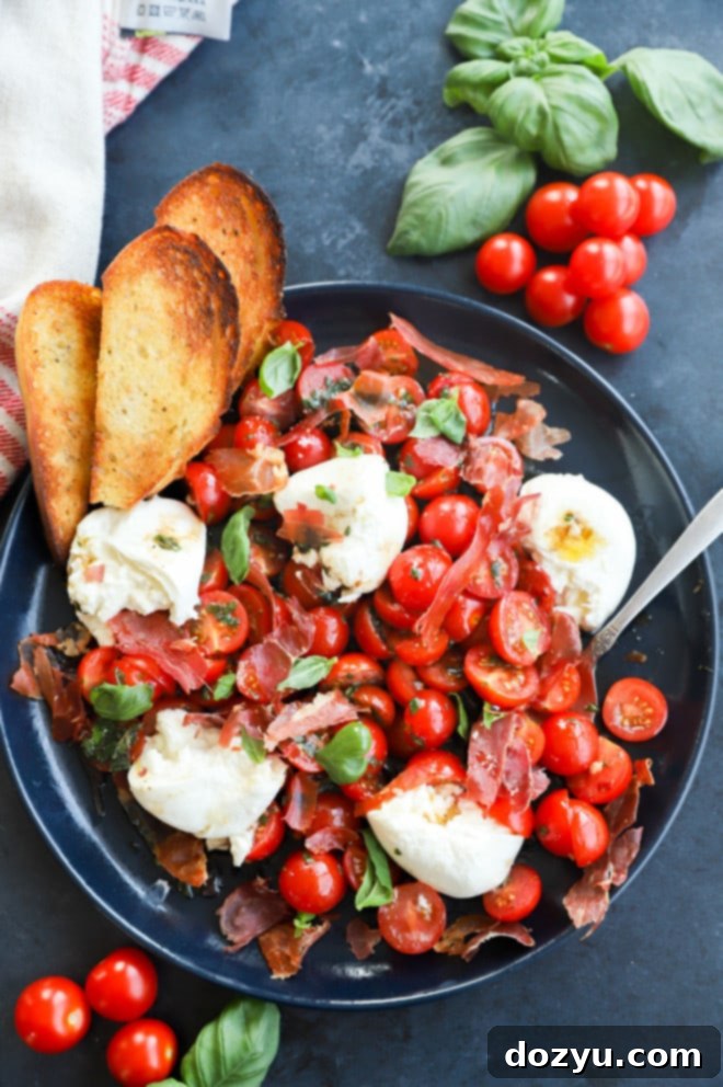 Creamy Burrata Caprese Salad 5 Image of summer tomato and cheese appetizer on plate