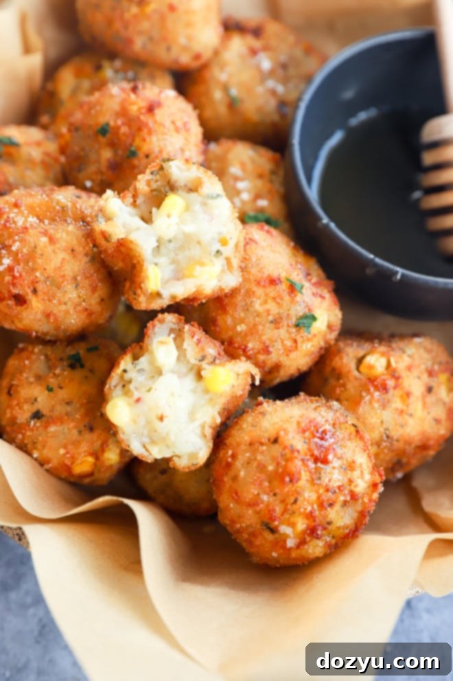 Cheesy Corn Bites 11 A bowl of cheese corn balls ready to be served, showcasing their perfect golden-brown color and inviting texture.