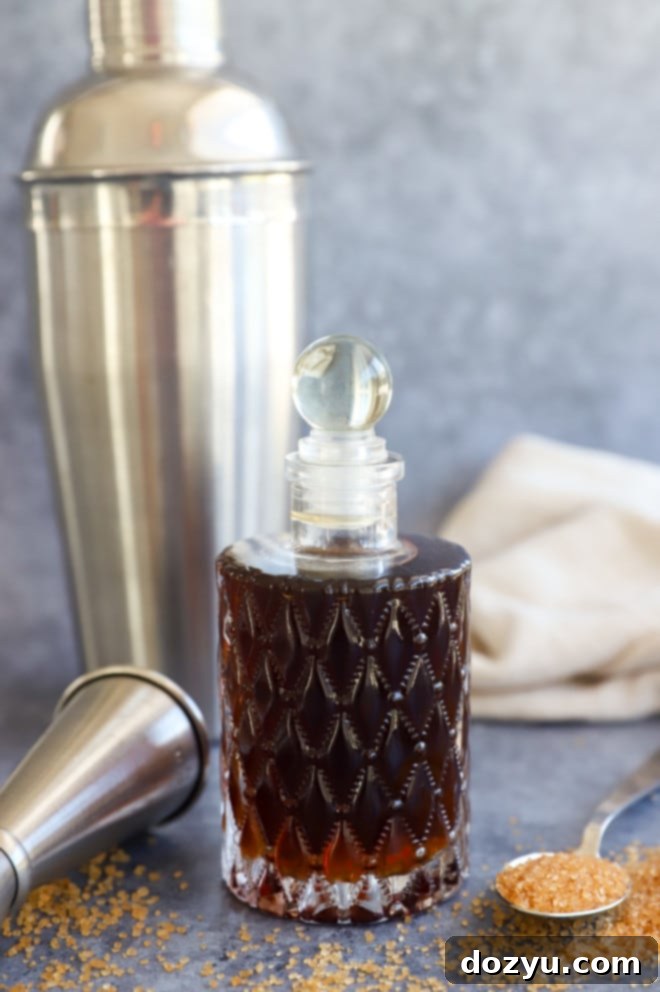 Golden Cane Syrup 8 Demerara syrup in a bottle with cocktail tools like a jigger and strainer