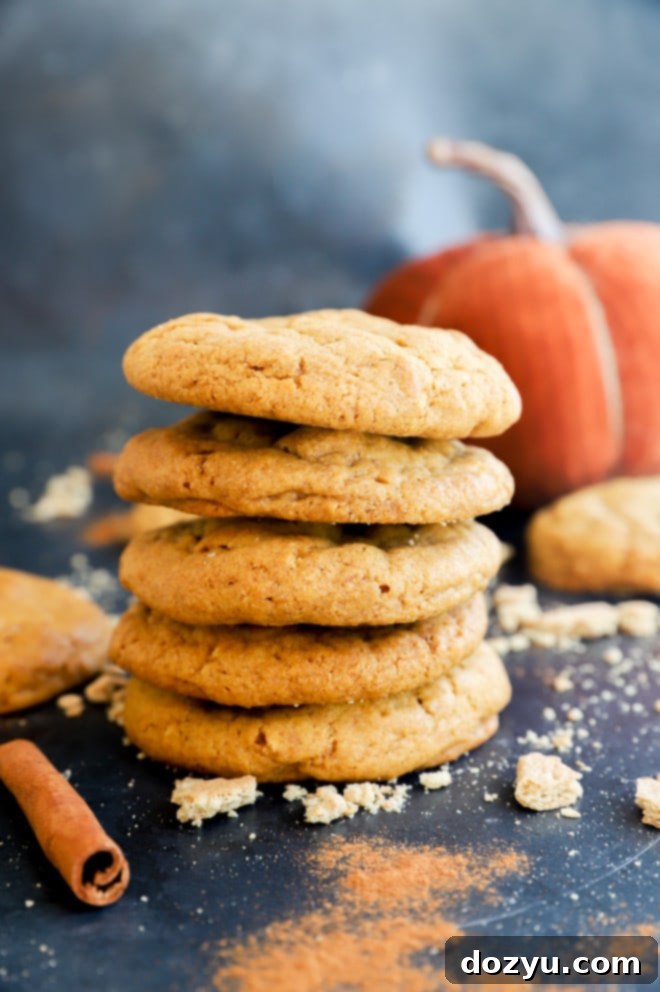 Spiced Pumpkin Cheesecake Cookies 9 Stack of pumpkin cheesecake cookies with cinnamon sticks