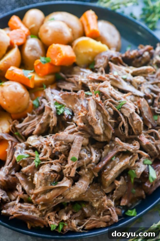 Fork-Tender Instant Pot Pot Roast 11 Instant pot roast beef on a plate with vegetables and gravy