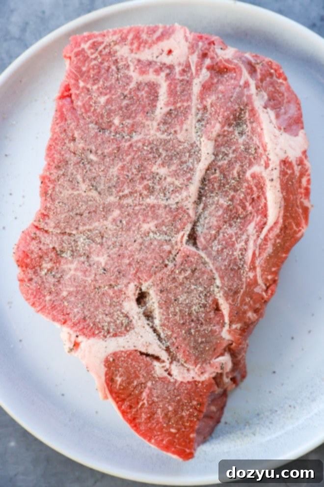 Fork-Tender Instant Pot Pot Roast 5 chuck roast seasoned with salt and pepper on a plate