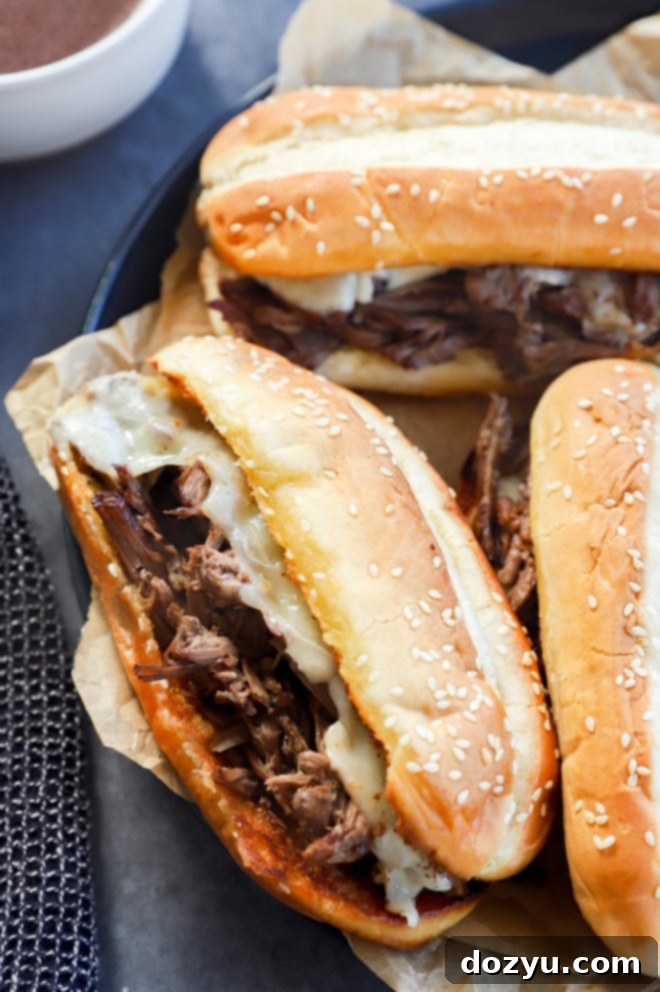 Ultimate French Dip 7 Beef dip sandwiches on a platter with parchment paper