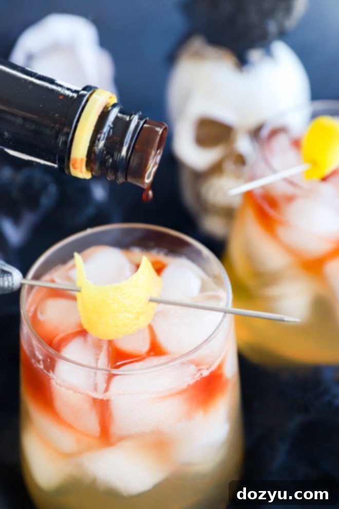 Shadow Veil Elixir 4 Adding angostura bitters to a spooky drink