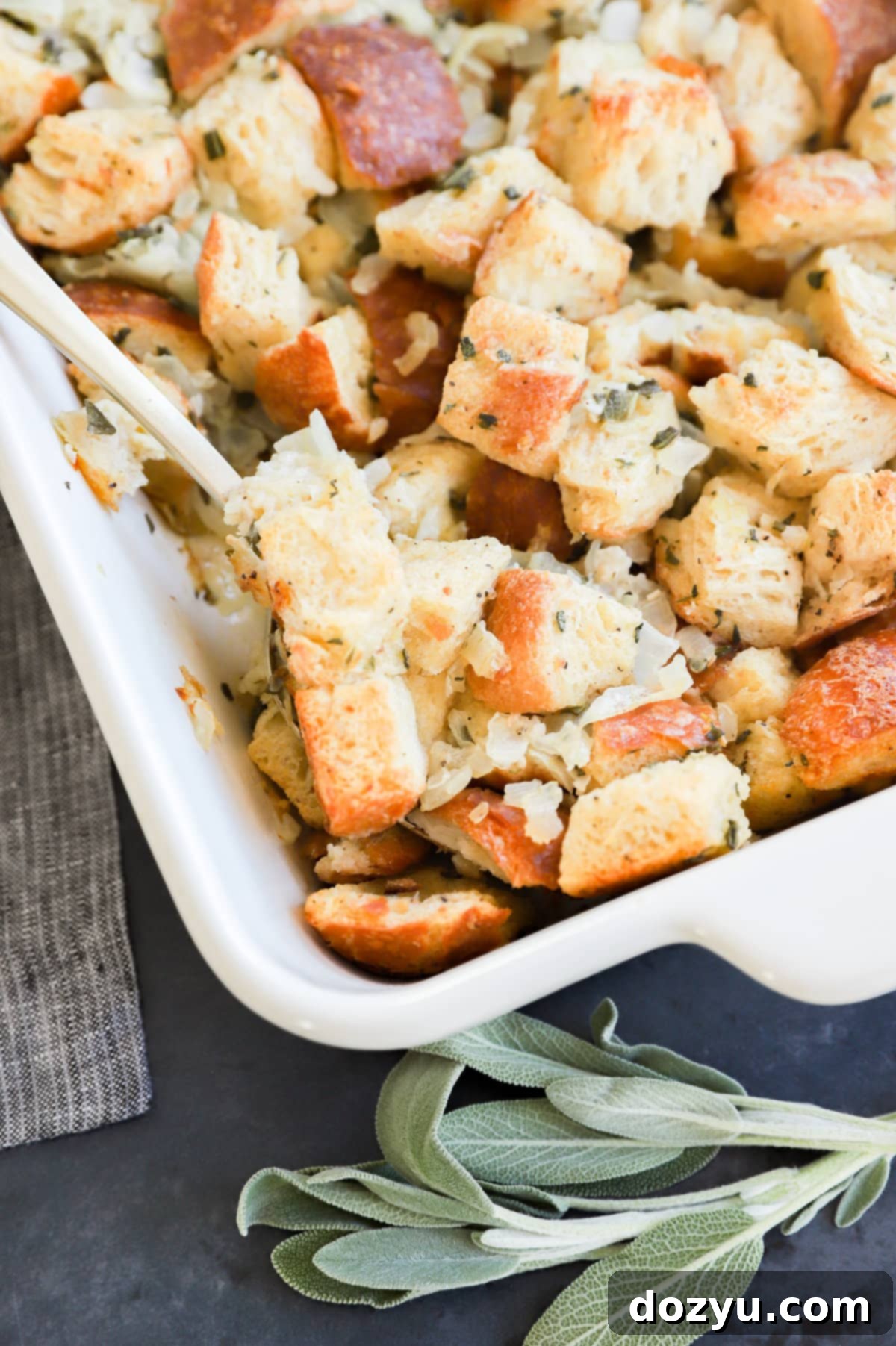 Perfect Sage and Onion Stuffing 11 Sage and Onion Stuffing in a baking dish, garnished with fresh sage.