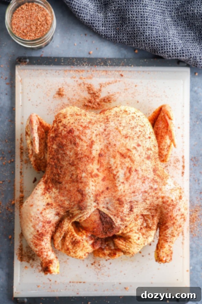Perfectly Smoked Chicken 4 Ingredients for whole smoked chicken on cutting board