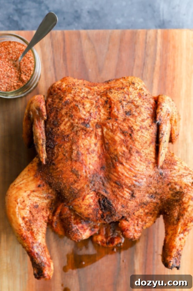 Perfectly Smoked Chicken 7 Bird on cutting board with dry rub