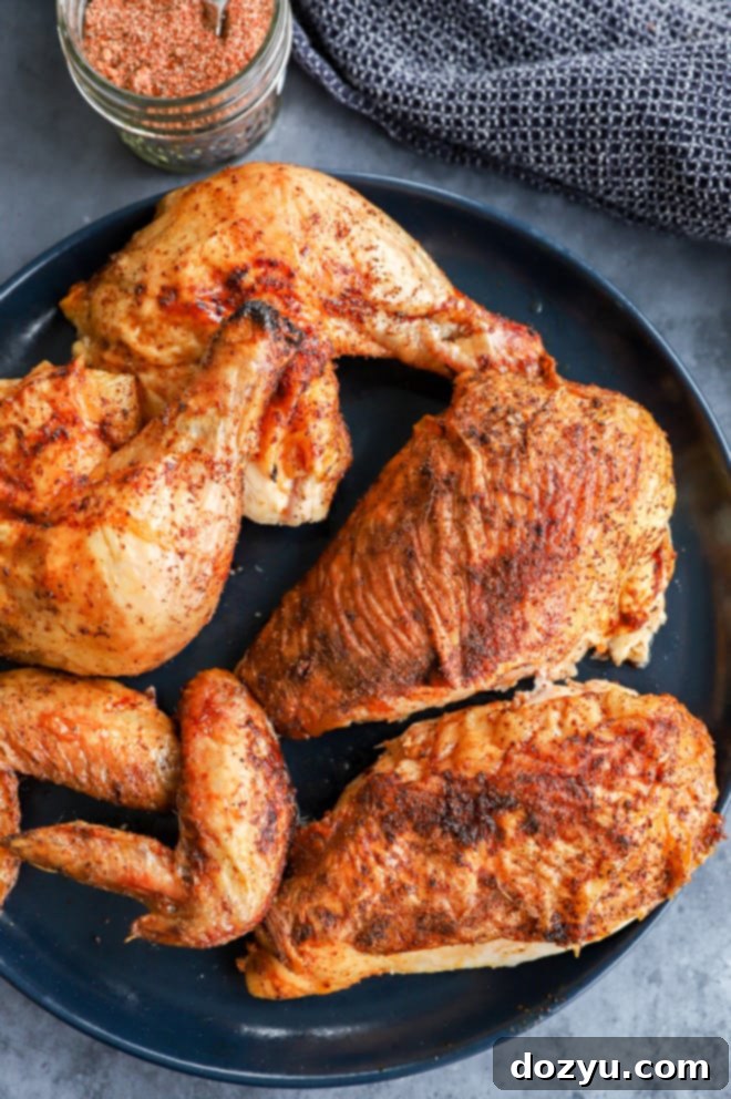 Perfectly Smoked Chicken 8 Carved bird on plate with dry rub