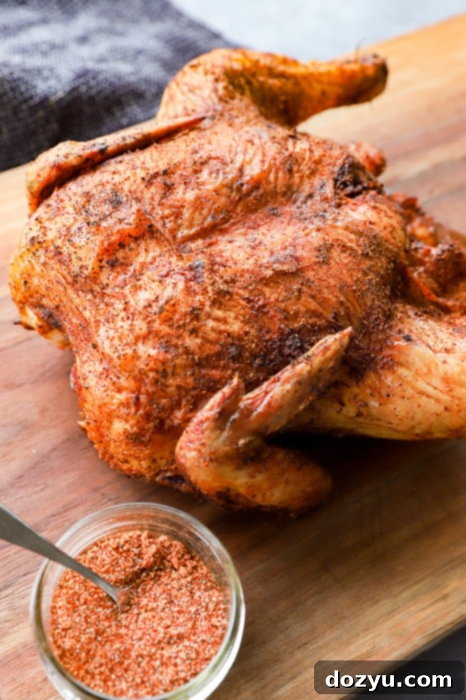 Perfectly Smoked Chicken 9 Poultry on cutting board with dry rub and spoon