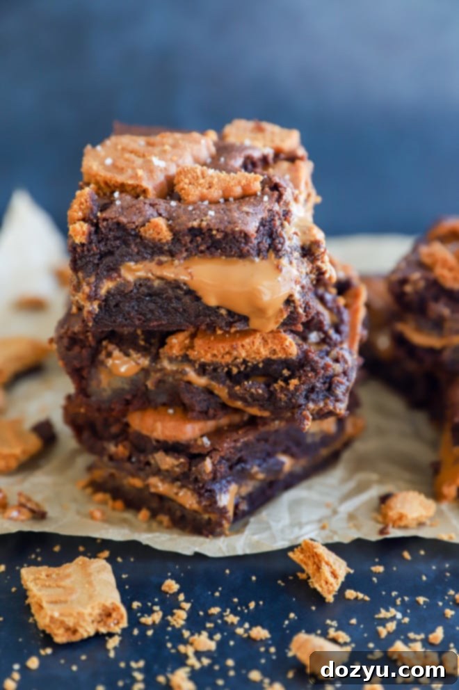 Decadent Biscoff Brownies 9 Stack of chocolate cookie butter treats on parchment paper