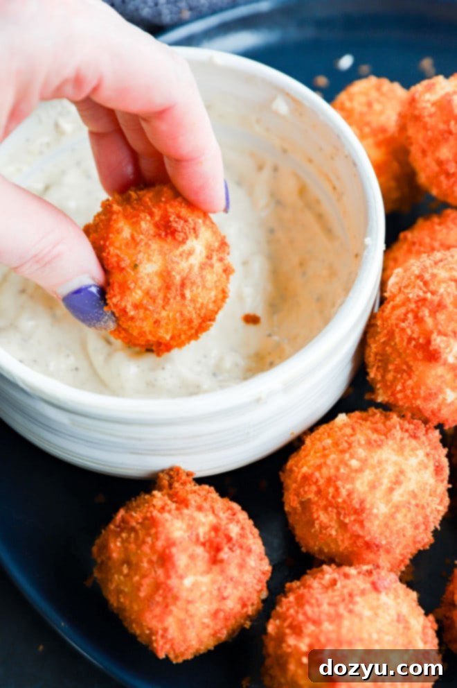 Golden Cheesy Potato Bites 8 Dipping potato cheese balls in aioli, showcasing the versatility of serving options