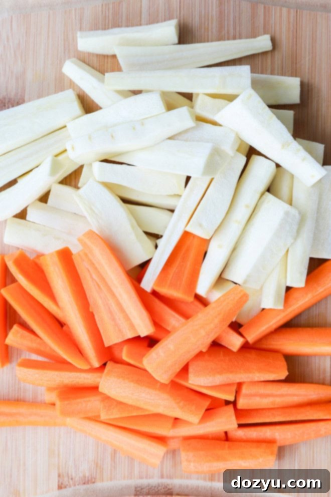 Golden Honey-Kissed Root Vegetables 4 raw carrots and parsnips on cutting board